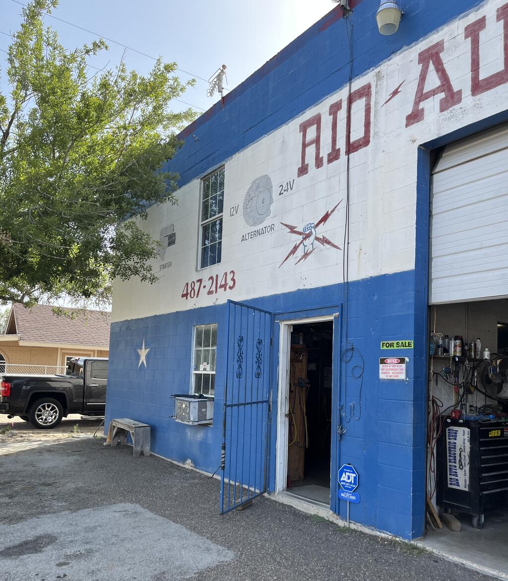 Building entrance with a security door beside one of the overhead shop doors