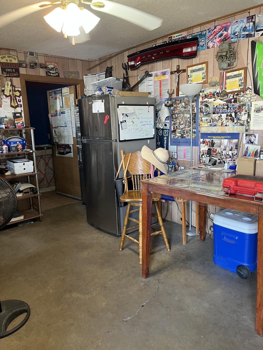 Front office and customer room with ceiling fan and interior door to the shop